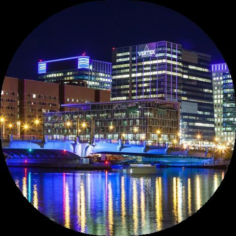 An image of the Vertex headquarters in Boston lit up at nighttime