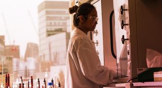 A Vertex scientist operating equipment in the lab